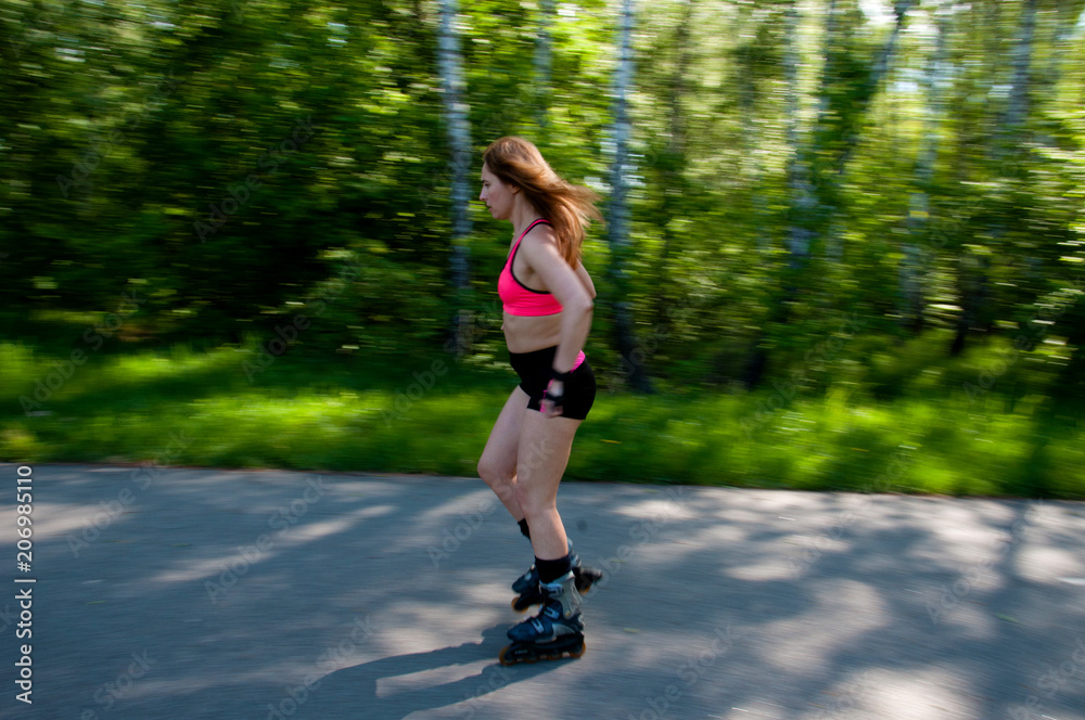Roller skating woman in park rollerblading on inline skates. Beautiful woman learns to roller skate in the park. Rear view, front view, side view Roller skating woman in park rollerblading on inline skates. Beautiful woman learns to roller skate in the park. Rear view, front view, side view