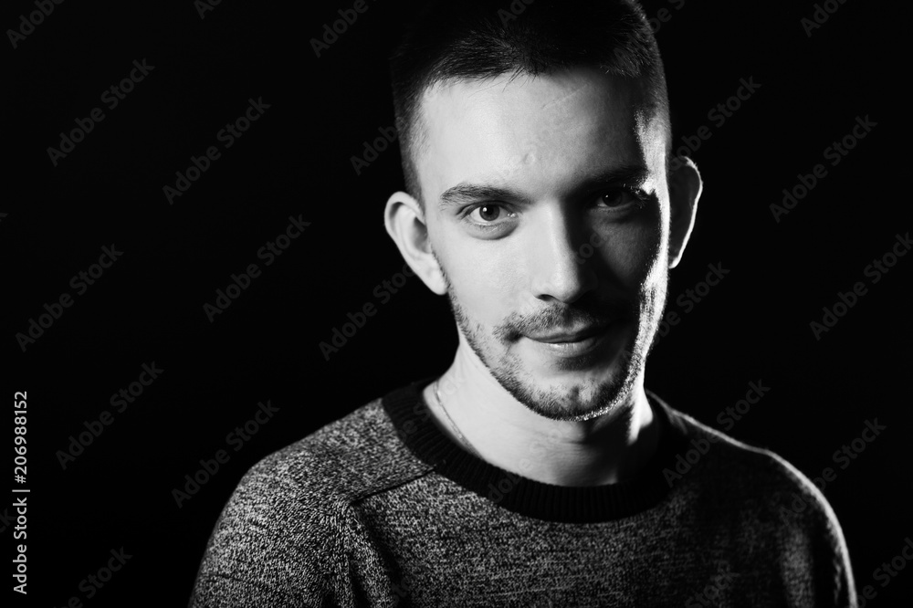 Portrait of a handsome young man. Black background. Portrait of a handsome young man. Black background.