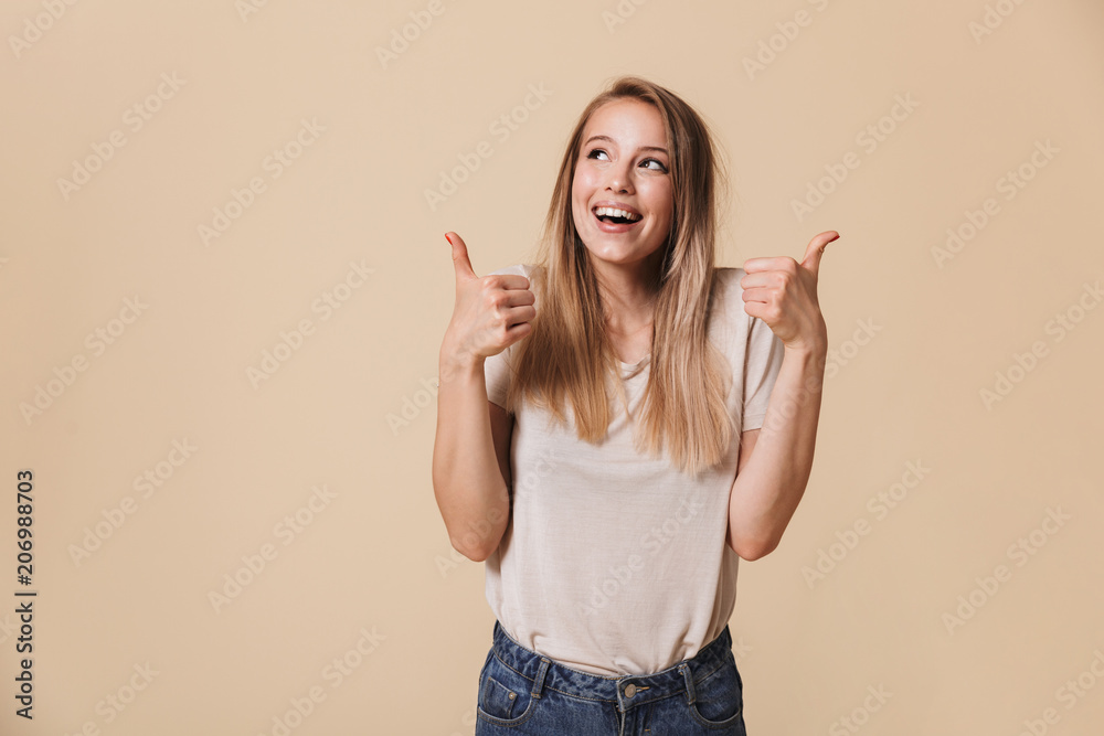 Portrait of a smiling casual girl showing thumbs up Portrait of a smiling casual girl showing thumbs up