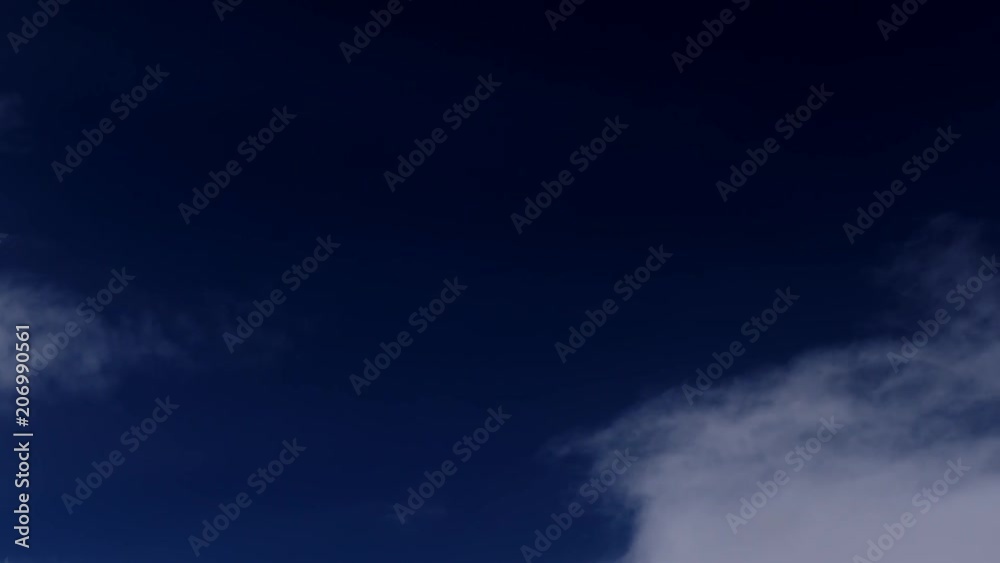 Clouds moving fast against a deep blue night sky Clouds moving fast against a deep blue night sky