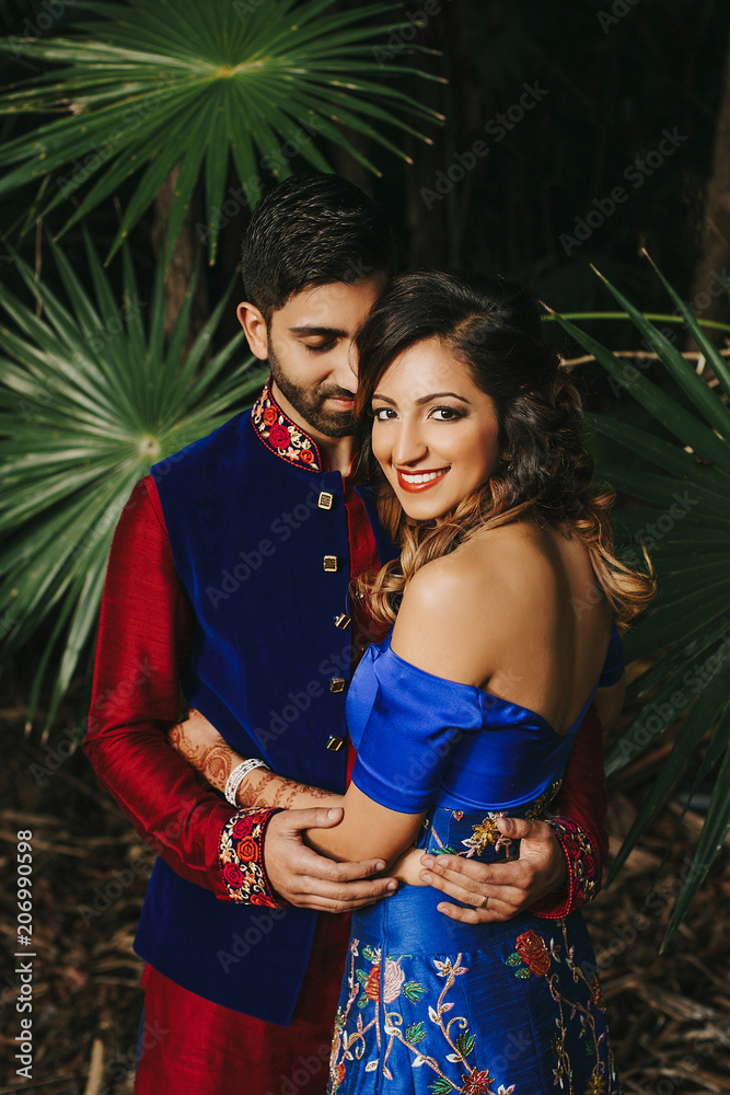 Photo of Beautiful royal blue lehenga with work all over and groom in  maroon sherwani