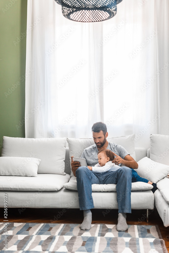 Father and Baby Looking at Tablet Father and Baby Looking at Tablet
