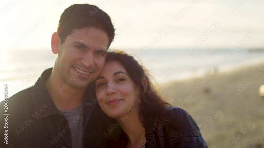 Beautiful Portrait Of Happy Couple Smiling On The Beach At Sunset (Slow Motion) Beautiful Portrait Of Happy Couple Smiling On The Beach At Sunset (Slow Motion)