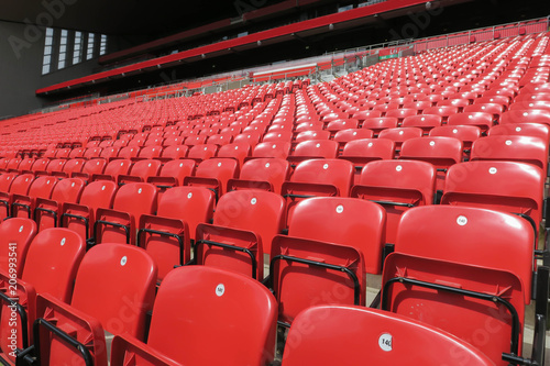 Red chair rows in football stadium.