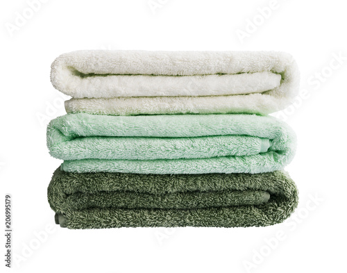 Big green and white bath towels in stack. Isolated over white background