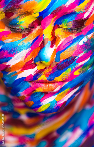 Portrait of the bright beautiful girl with painting art colorful make-up on face and bodyart. Creative vertical ads banner or flyer with copy space.
