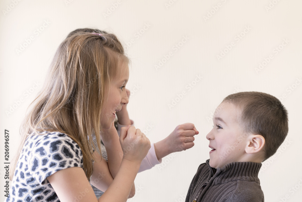 Two little girls beat the boy. Light background. European appearance. Two little girls beat the boy. Light background. European appearance.