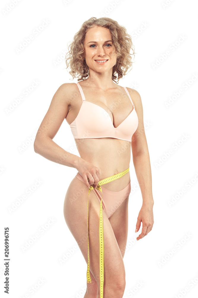 Obraz premium Healthy female body with measuring tape