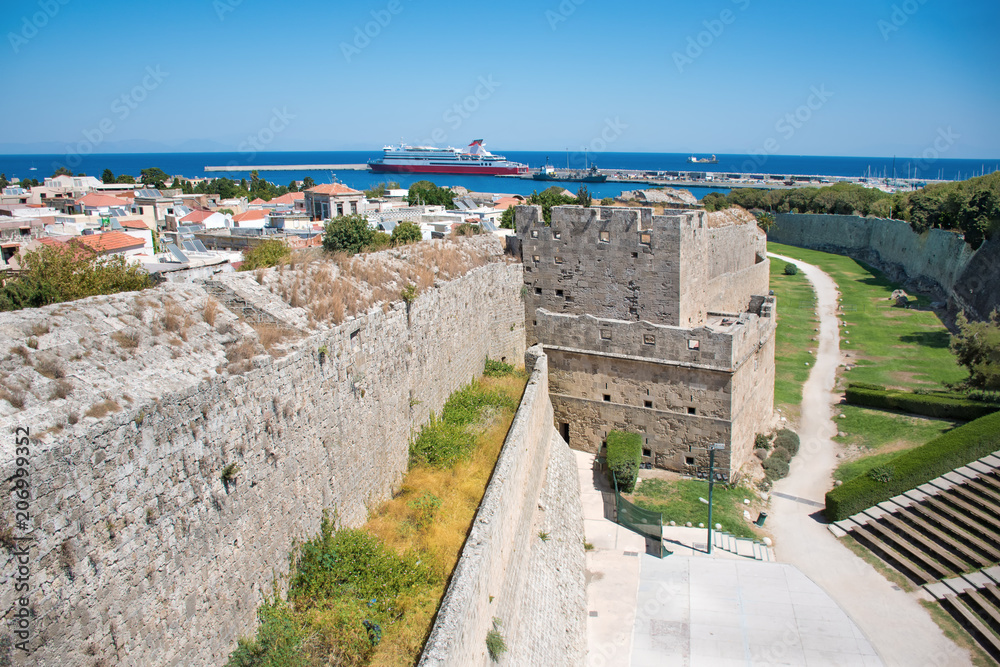 View of city walls, open air theatre, and harbor in City of Rhodes (Rhodes, Greece)