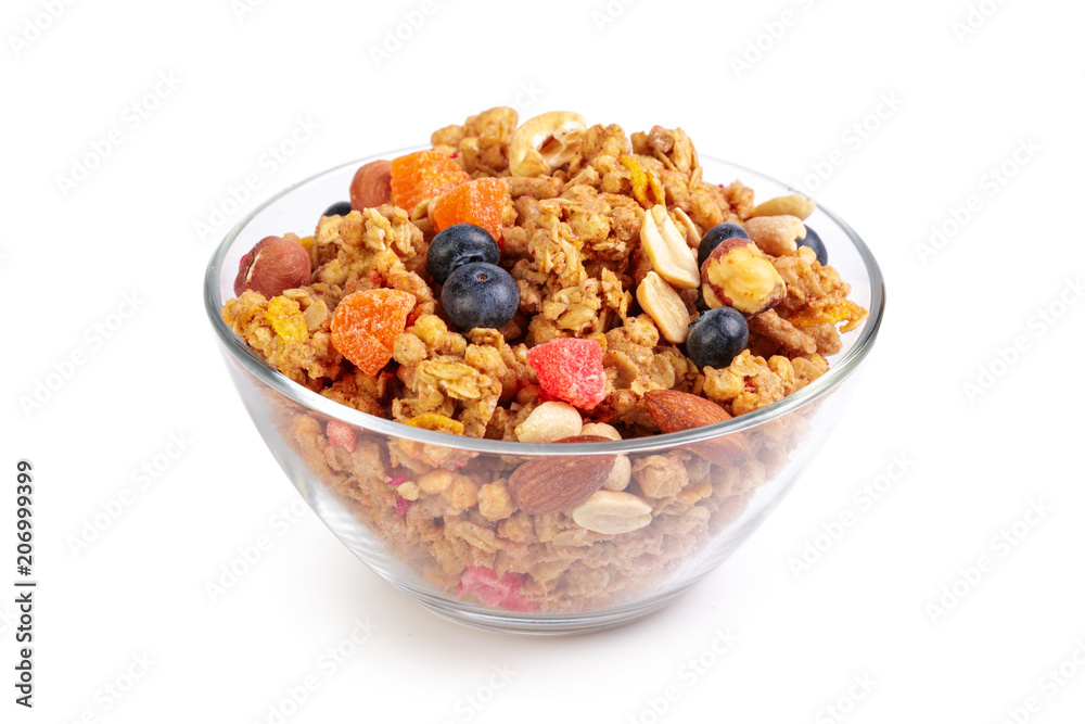 Bowl of homemade granola with fruit pieces isolated on white