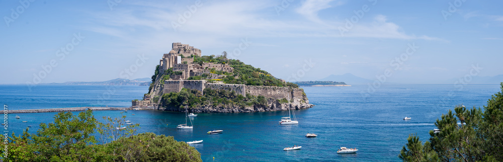 Ancient castle on the island in the blue sea panorama Ischia