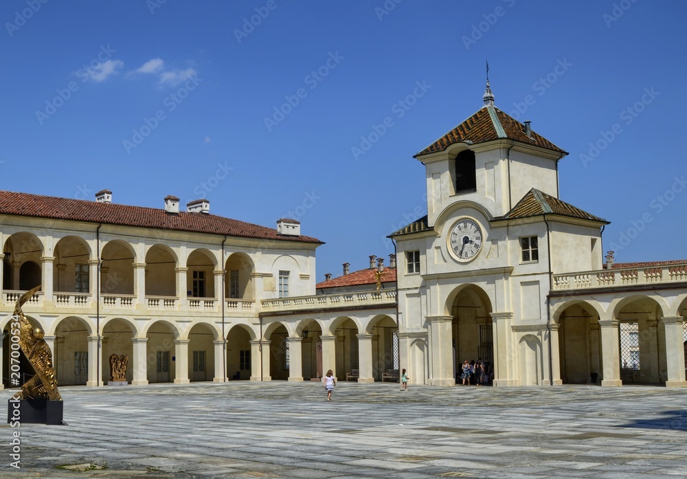 Venaria Reale, Piedmont region, Italy. June 2017. Entrance to the palace of the clock tower, adjacent to the deer's fountain.