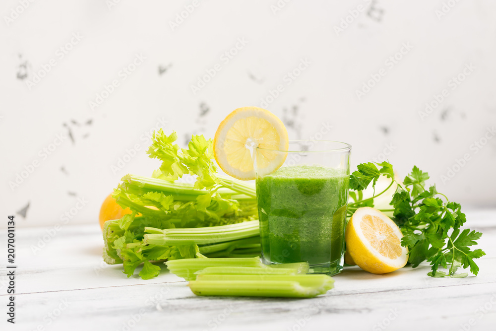 Green cocktail smoothie parsley celery lemon lime slices, healthy drink ingredients, glass of