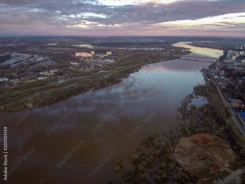 full-flowing river at sunset from a bird's eye view