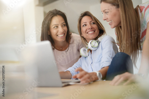 Girl friends websurfing on internet with laptop