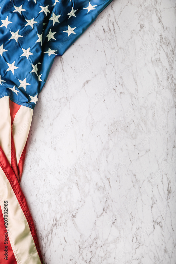 Fototapeta premium Close-up american flag on white marble background