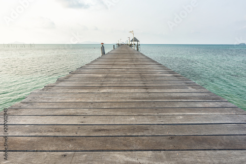 Long wooden bridge go to pavilion on the sea in beautiful tropical island, Thailand.