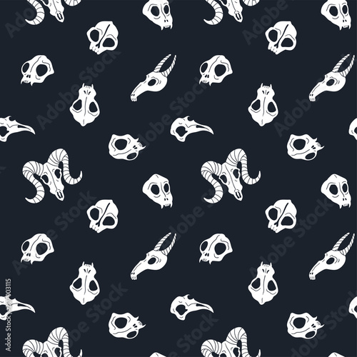 Vector seamless pattern of animal skulls. Background with cute skulls on the black background.