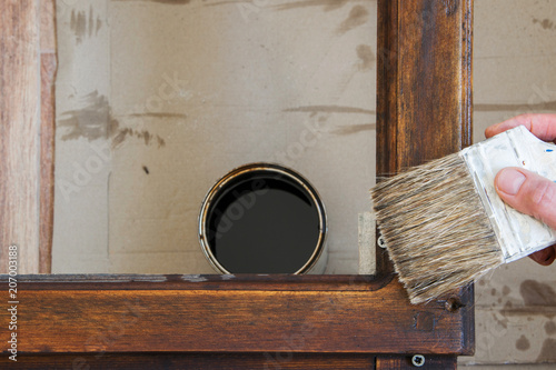 Fotografía Top view of woman hand brush with colored lacquer wooden table indoors