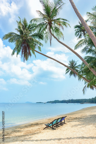 Beach chairs on the white sand beach and tropical sea in Thailand.