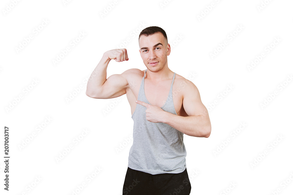 Young and sexy fitness trainer man pointing at his biceps and looking at camera over white background Young and sexy fitness trainer man pointing at his biceps and looking at camera over white background