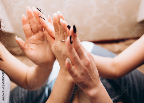 The sisters touching fingers to each other