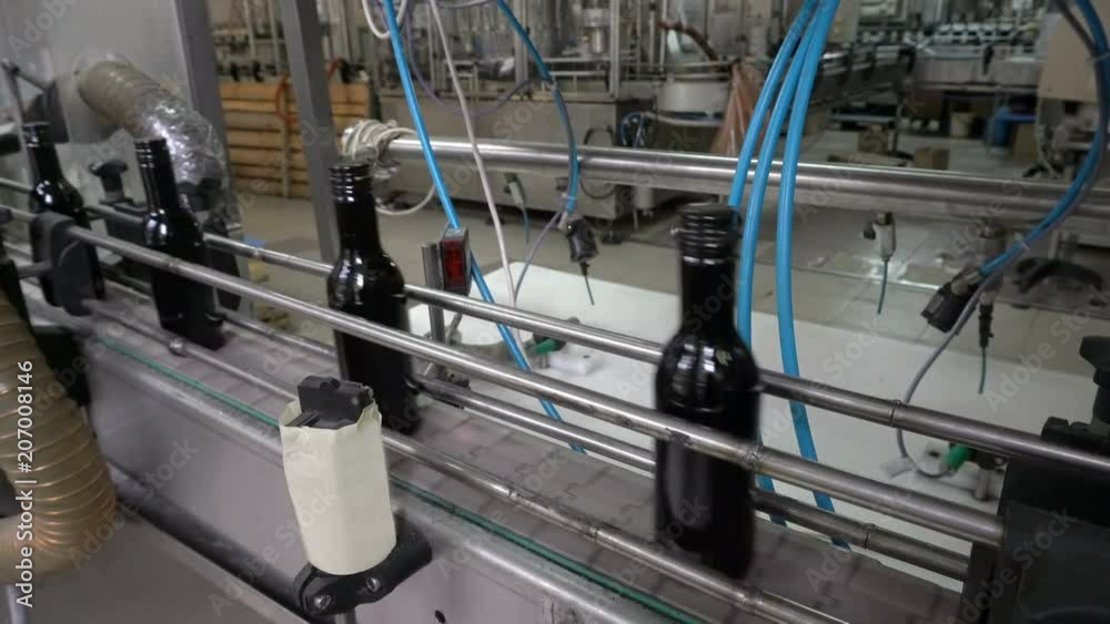 Bottling and sealing conveyor line at winery factory Bottling and sealing conveyor line at winery factory