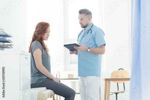 Doctor diagnozing a female patient