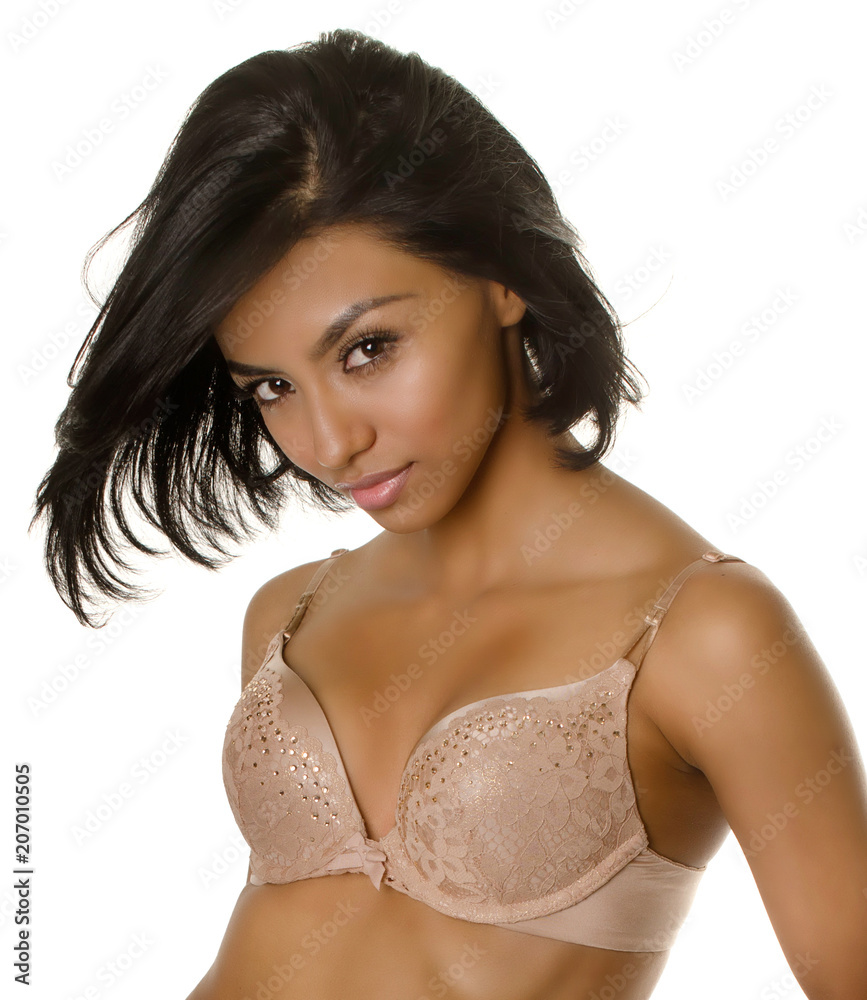Beautiful young woman wearing bra Photos | Adobe Stock