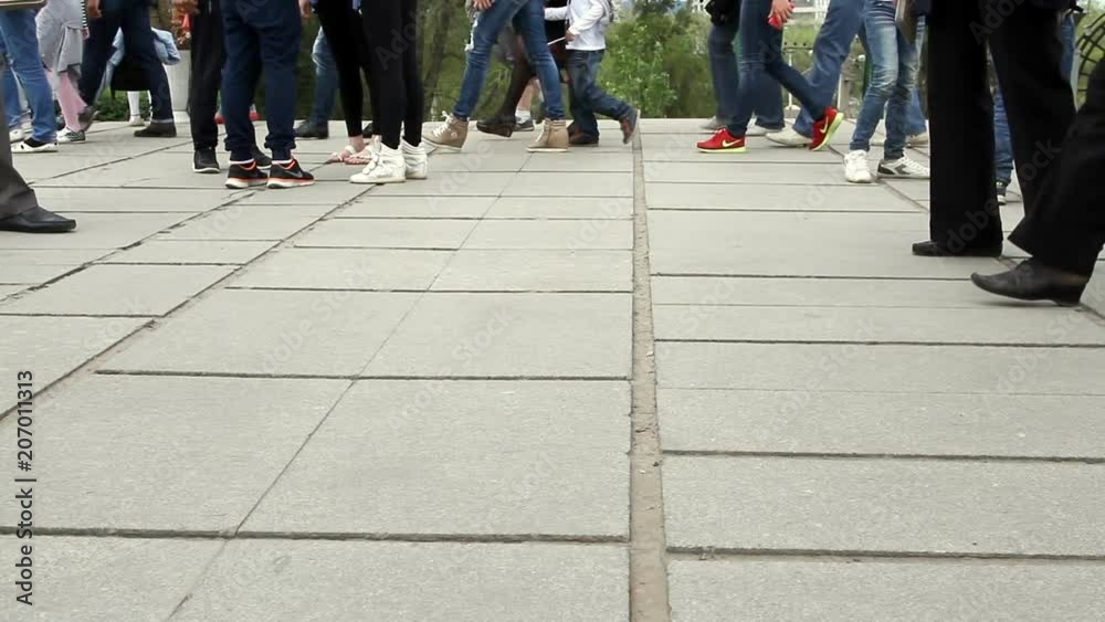 People cross the road at a pedestrian crossing. People cross the road at a pedestrian crossing.