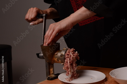 Woman stirring cooked minced meat in kitchen photo