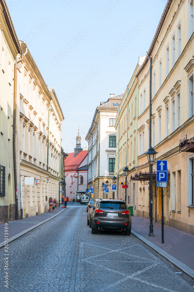 European street with parked cars near the sidewalk