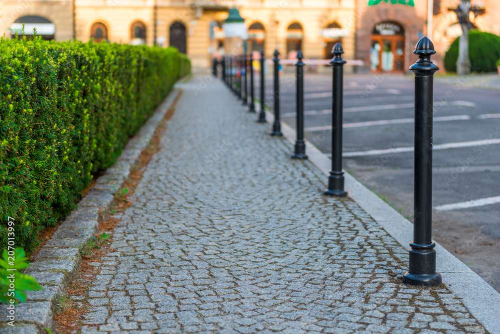 Fototapeta premium sidewalk, lined with gray paving stones closeup