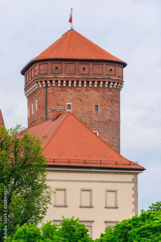 Krakow, Poland - August 13, 2017: Krakow, high brick tower - Wawel Castle on blue sky background Krakow, Poland - August 13, 2017: Krakow, high brick tower - Wawel Castle on blue sky background