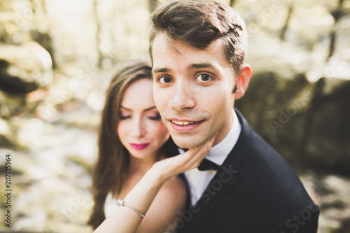 Beautiful, perfect happy bride and groom posing on their wedding day. Close up portrait