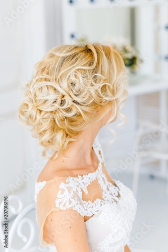 Bride's airstyle for the wedding. girl with blond hair in studio