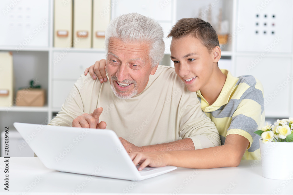 portrait of boy and grandfather with a laptop portrait of boy and grandfather with a laptop