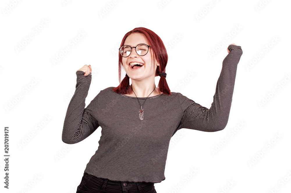 Young cheerful redhair woman with raised arms celebrating Young cheerful redhair woman with raised arms celebrating