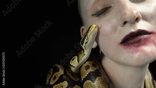 Ball python near woman's face