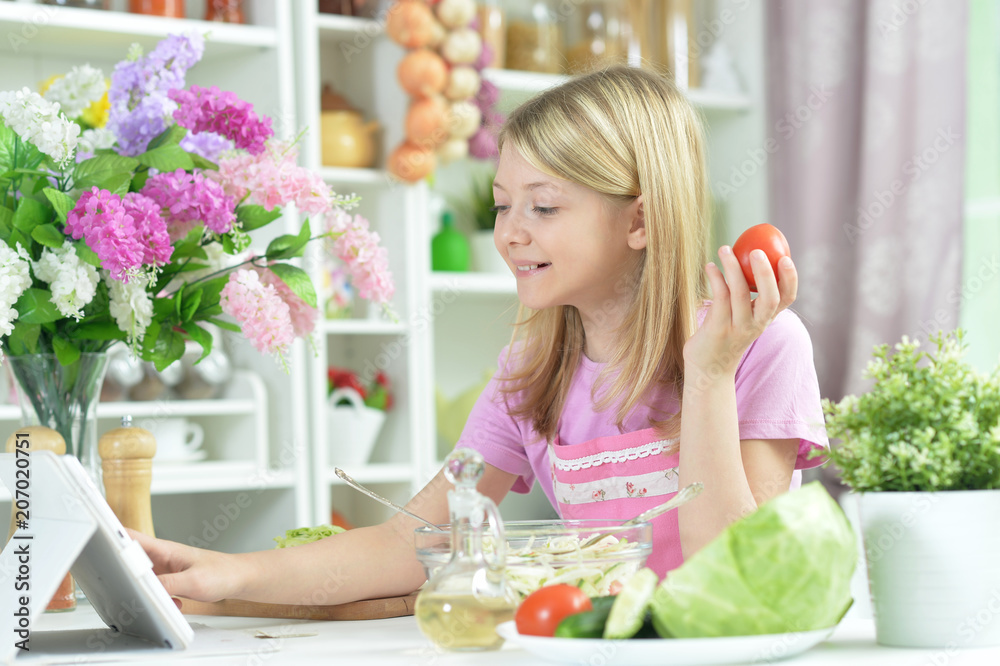 Cute little girl preparing fresh salad