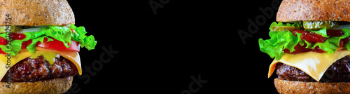 Burger wide banner or flyer with place for text. Big tasty hamburger or cheeseburger on black background with grilled meat, cheese, tomato, bacon, onion