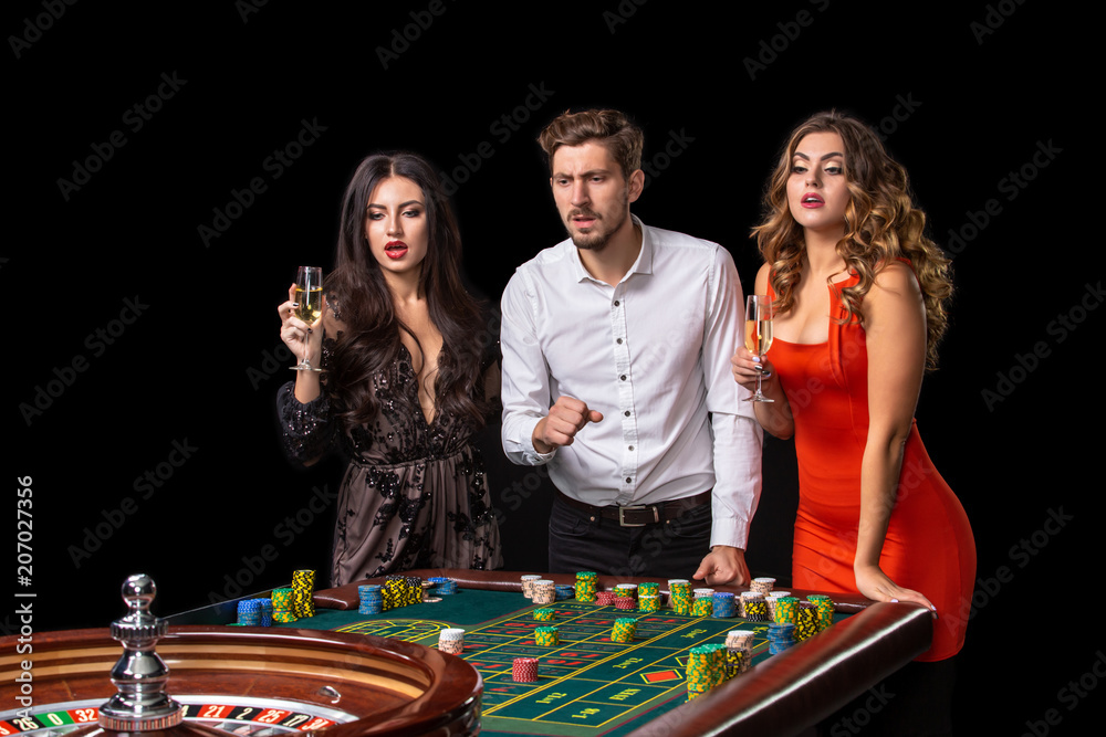 Group of young people looking excited at spinning roulette Group of young people looking excited at spinning roulette