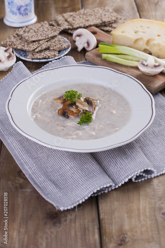 Mushroom cream soup on white wooden board. top view. cipy space.