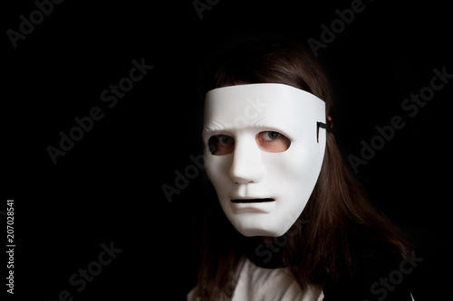 Portrait of a girl in a white mask on a black background