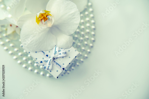 Gift box and white orchid on a white background 