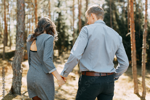 Pre-wedding photo shoot in the forest in nature, in the form of walking and traveling. Beauty of the North and Russia. Loving people and beautiful scenery. They laugh, sit and smile. Beautiful couple © pavelvozmischev