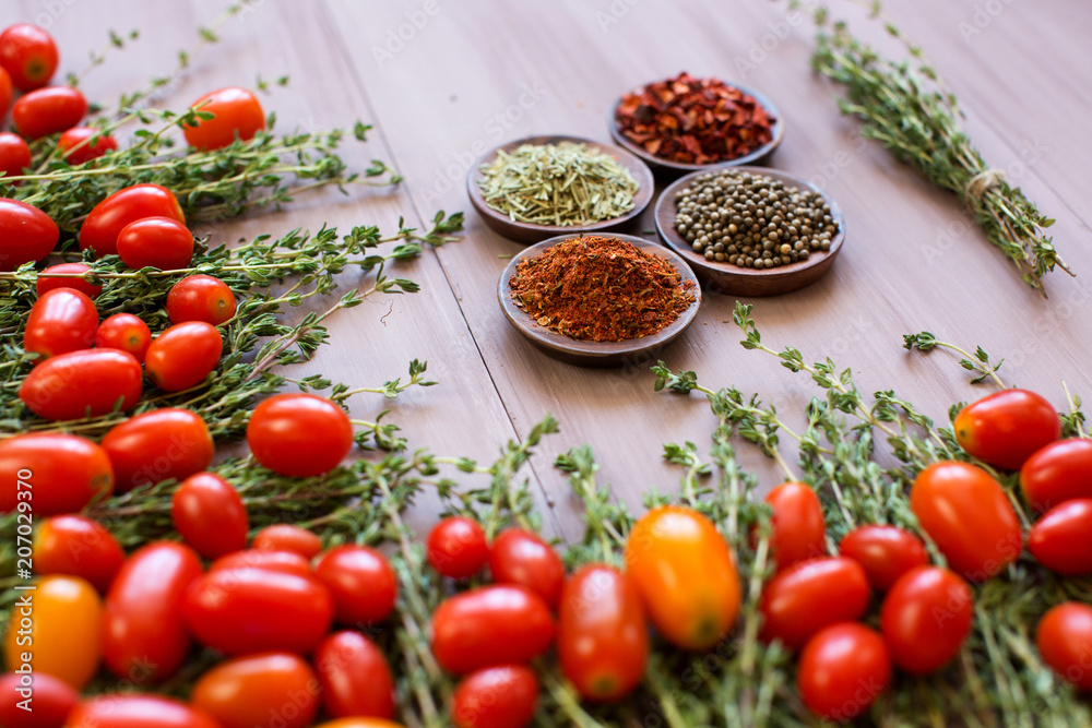 Cherry tomatoes and spices on a wooden background close-up. Cherry tomatoes and spices on a wooden background close-up.