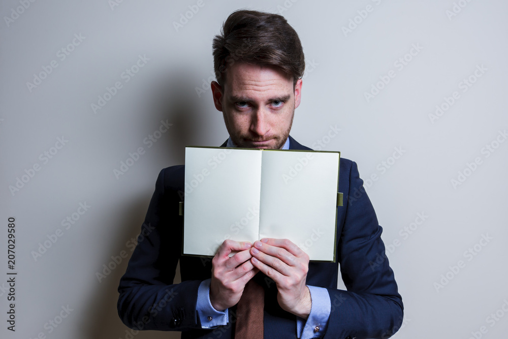 Angry business man showing blank note. Studio portrait isolated. Angry business man showing blank note. Studio portrait isolated.