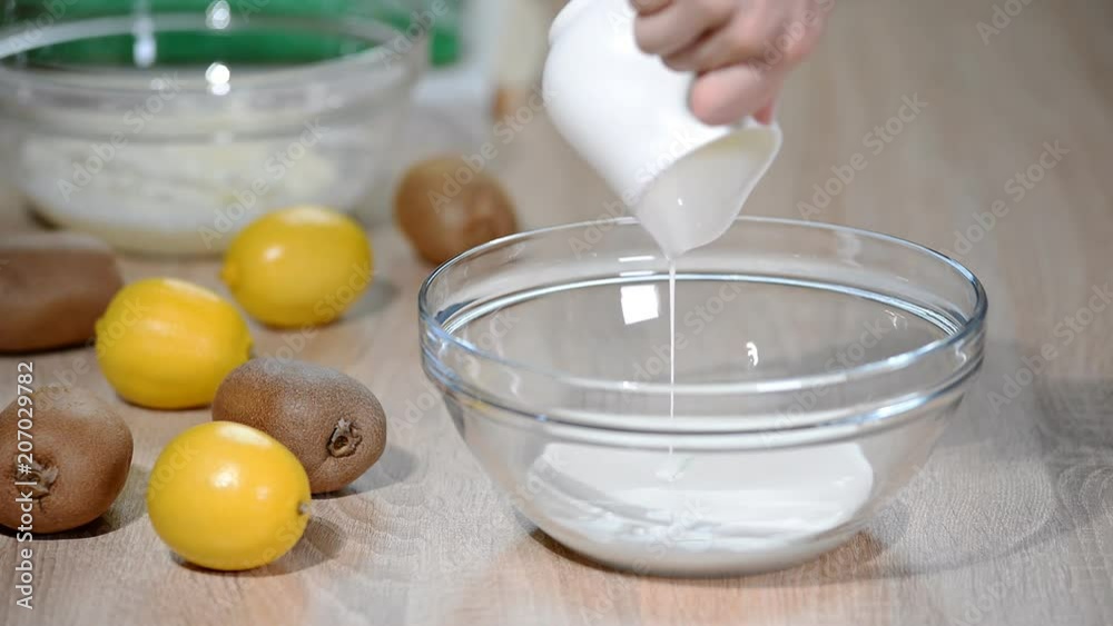 Cream pouring into a bowl. Cream pouring into a bowl.