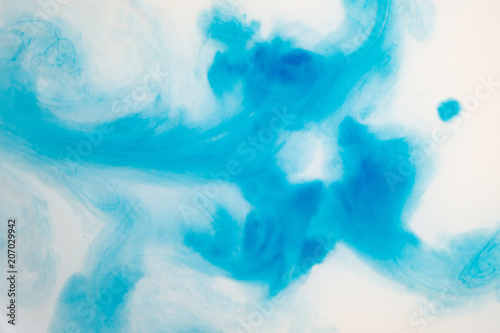 Blue watercolor painted on water. Abstract background